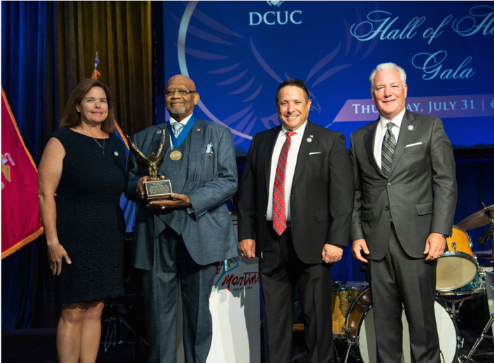 Raymond White Jr. accepting his award at the DCUC Hall of Honor gala